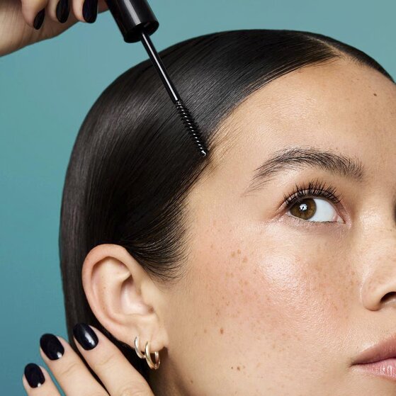 Model Slicking Down Fly Aways With Hair Gel Wand