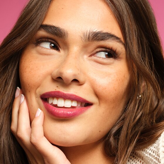 Model wearing lip stain marker in pink shade