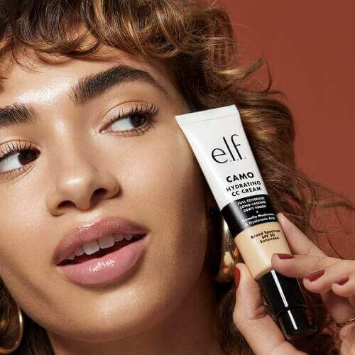Woman holding Camo Hydrating CC Cream with SPF 30