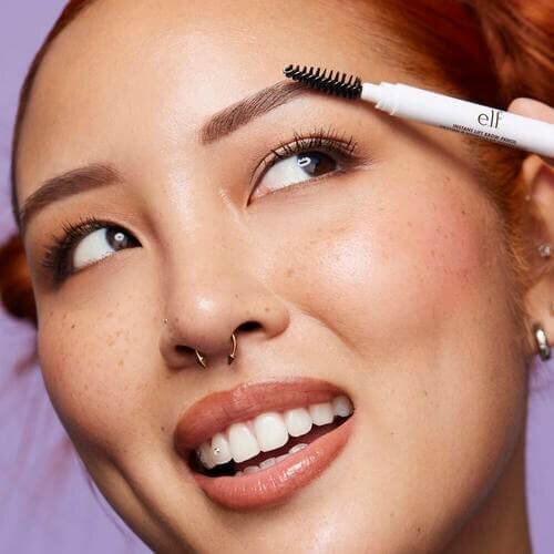 Woman applying e.l.f. Instant Lift Brow Pencil