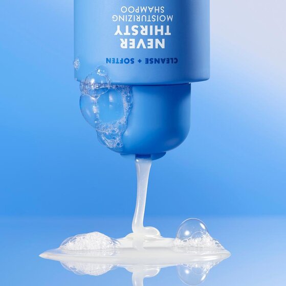 e.l.f. Never Thirsty Moisturizing Shampoo bottle dispensing rich, creamy lather with water bubbles