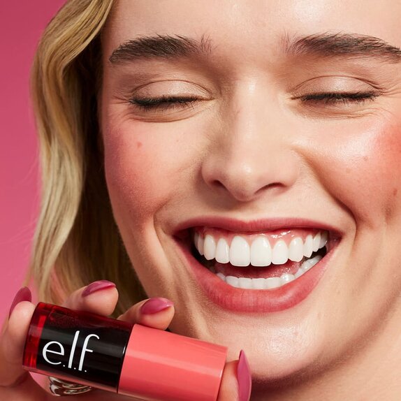 Model Applying Cheek Tint And Complexion Products To Face