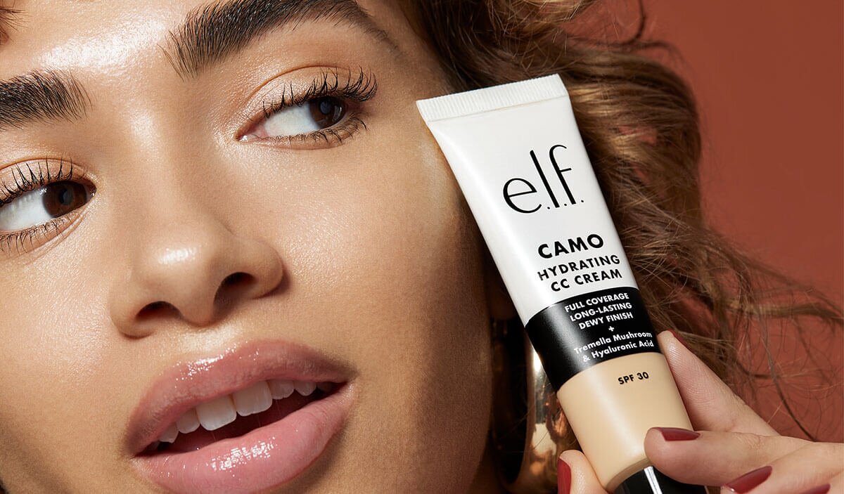 Model holding e.l.f. cosmetics camo hydrating cc cream with SPF 30