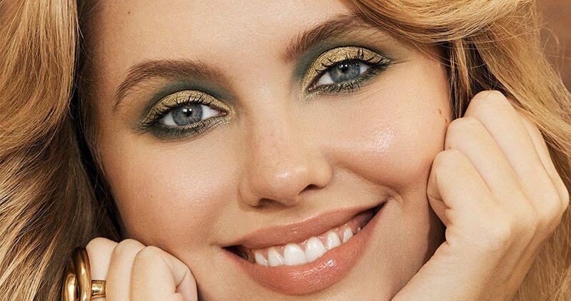 Application of Gold and Green Eyeshadow on Model