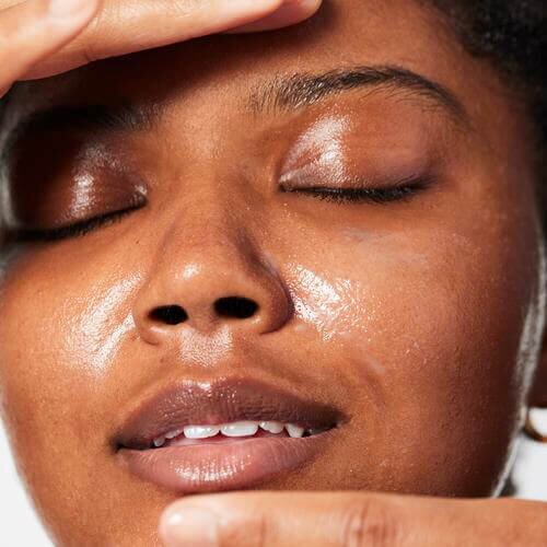 woman with cleansing balm on her face