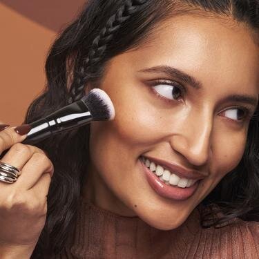 Model Applying e.l.f Makeup Using Brush