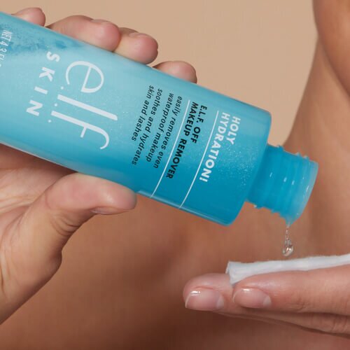 Pouring makeup remover onto a cotton pad