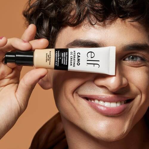 Male wearing and holding Camo CC Cream