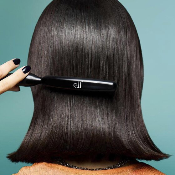 Model Slicking Back Hair With Boar Bristle Brush