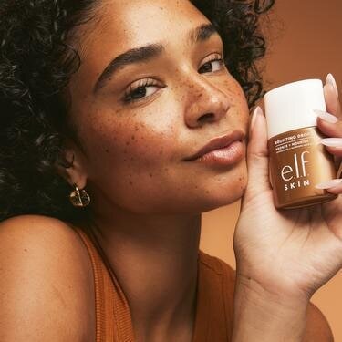 Woman Wearing and Holding Bronzing Drops