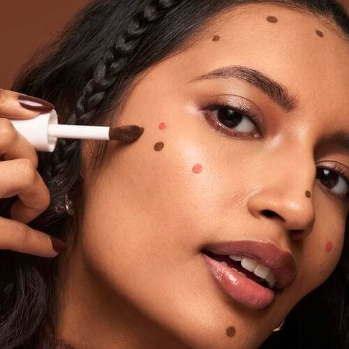 Model applying liquid bronzer and contour