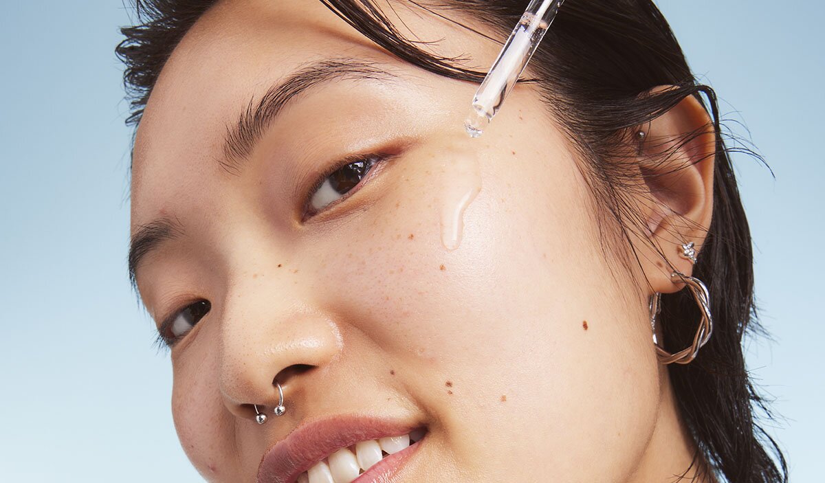 Model Applying Serums on Face