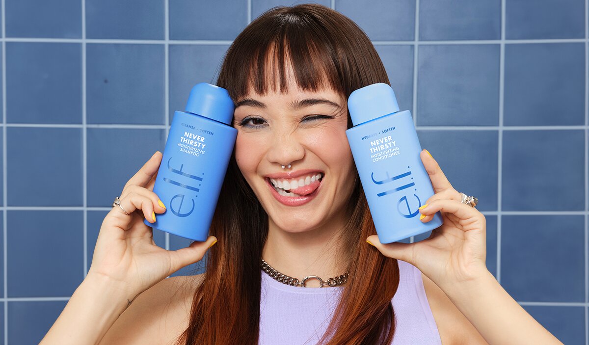 Model Holding e.l.f.'s Moisturizing Shampoo and Conditioner