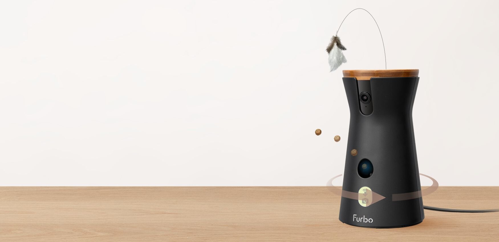 Die Furbo 360°-Katzenkamera steht ordentlich auf einem Holzregal vor einer neutralen Wand.