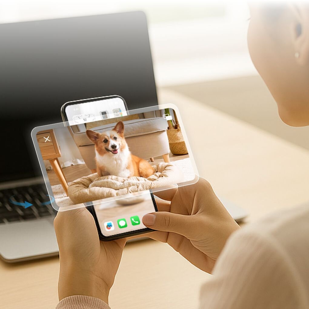 Woman looking at phone receiving Furbo Nanny alert that her dog Lucy is missing her with video clip of dog approaching camera