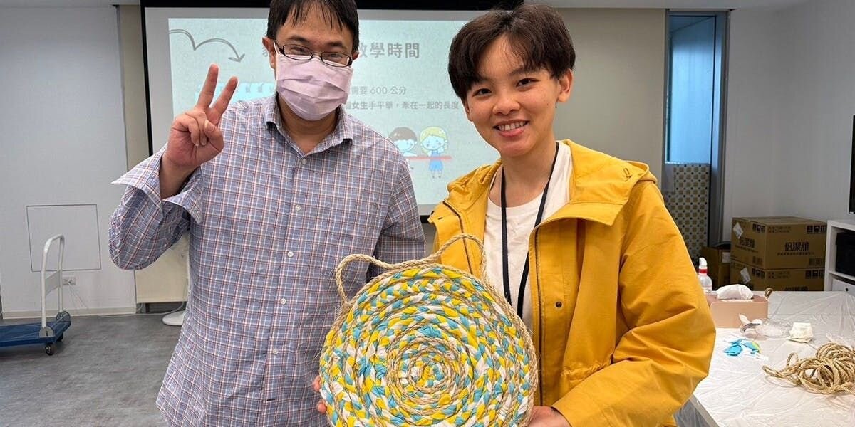 Two Furbo For Good Volunteers showing off their handmade cat scratcher