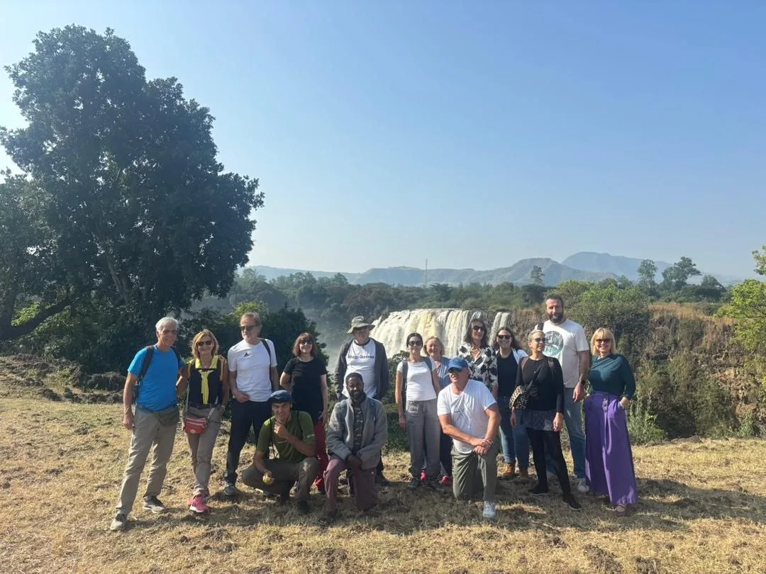 Group of travelers standing near a waterfall in Ethiopia