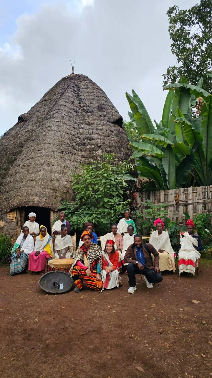 Travelers and a local guide standing in dry Ethiopian countryside
