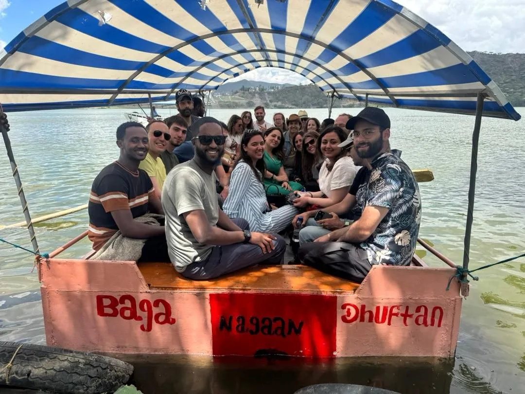 Group of travelers seated in a covered boat on Ethiopian water