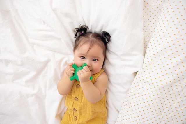 Toddler girl playing with Lovevery toy