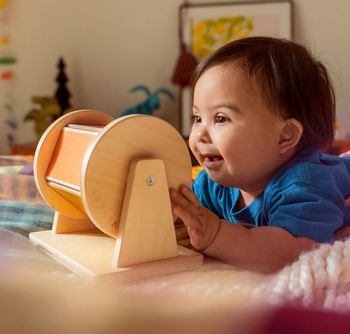 Boy playing with Lovevery puzzle