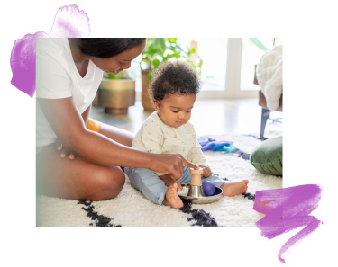 Mother and baby playing with a Lovevery's Tip and Turn toy