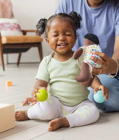 Child playing with Lovevery Cotton Doll