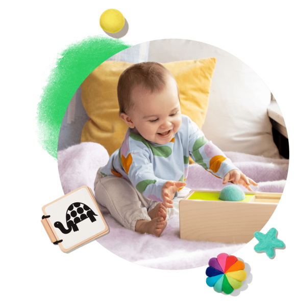Baby boy playing with sliding top box plaything