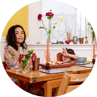 Mother and child sitting at the dining room table with flowers