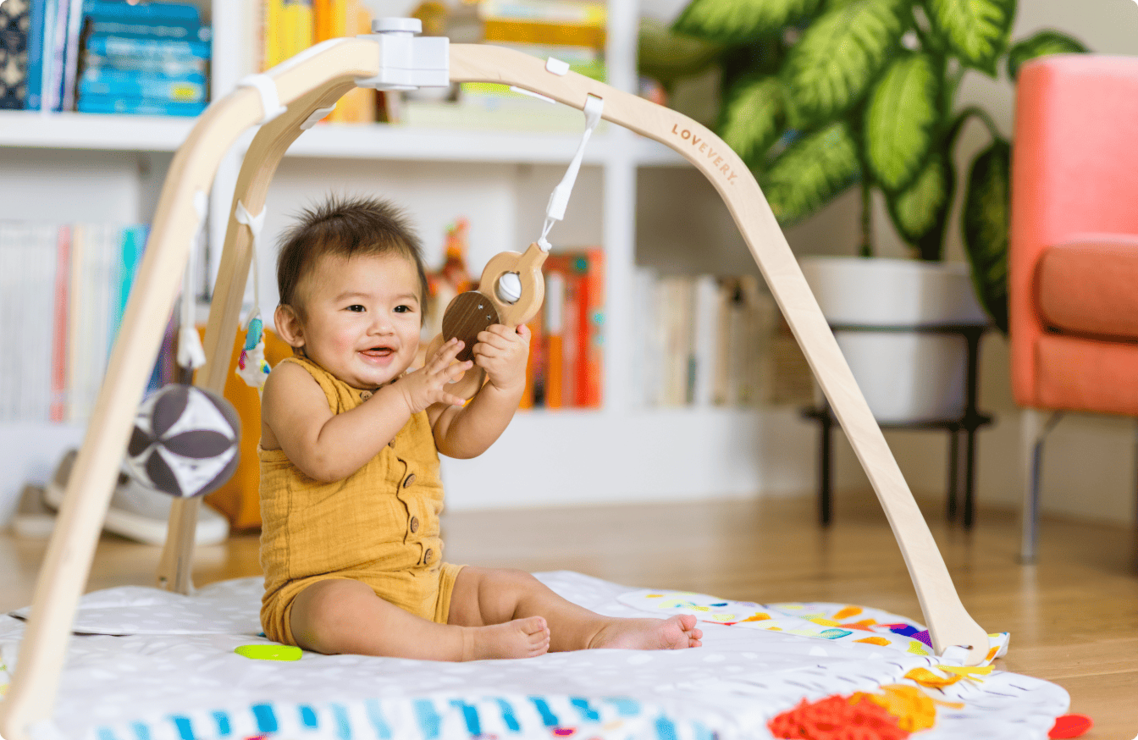 Baby playing with the Lovevery Play Gym