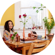 Mother and child sitting at the dining table with flowers