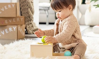 Toddler girl playing with Lovevery toy