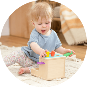 Baby playing with the Wooden Peg Drop