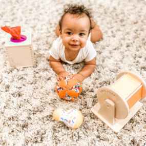 Baby playing with playthings from the Senser Play kit
