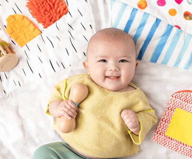 Baby with Lovevery Wooden Rattle and Play Gym