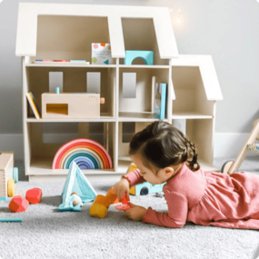 Girl playing with Van Go Outdoor Adventure peg people and sleeping bags