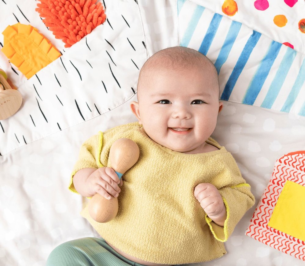 Baby with Lovevery Wooden Rattle and Play Gym