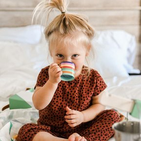 Child playing with the Lovevery Pinkies Up Picnic Set