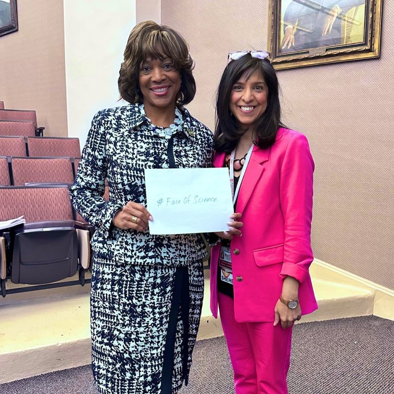 Dr. Valerie Montgomery Rice and Vinny Arora MD MAPP holding a #FaceOfScience sign
