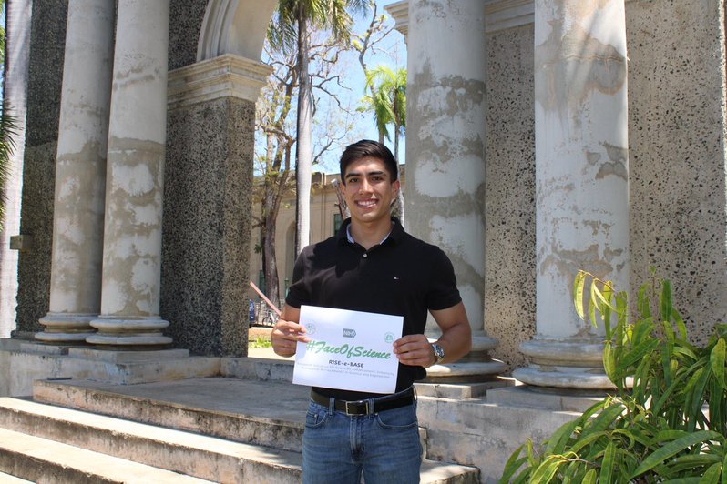 Mateo Cortez Cuervo holding a #FaceOfScience sign