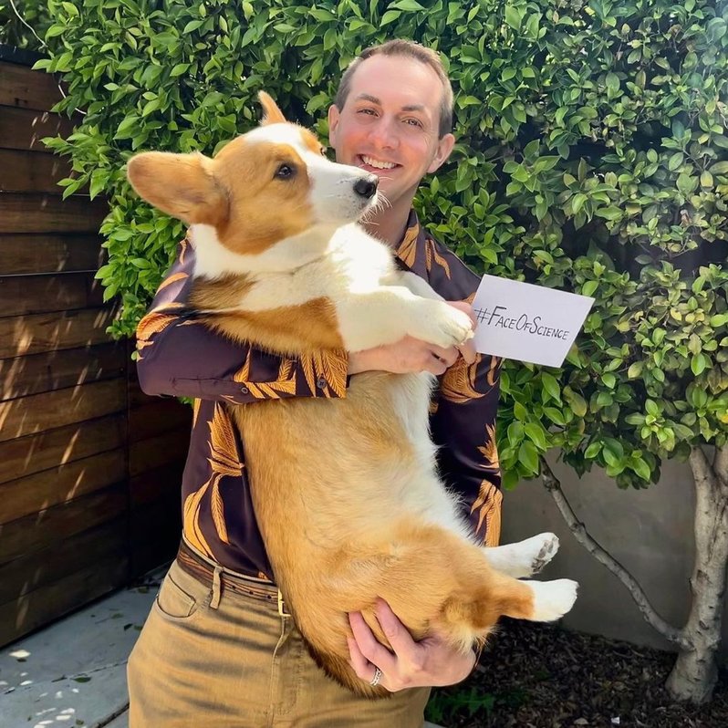 Brandon Yarns
holding up his dog and a #FaceOfScience sign