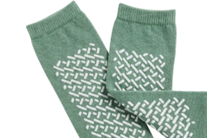 Green socks with grip features on the bottom.
