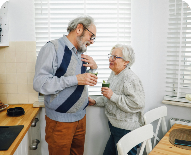 Image of an older couple chatting in a kitchen.