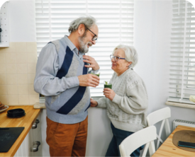 Image of an older couple chatting in a kitchen.