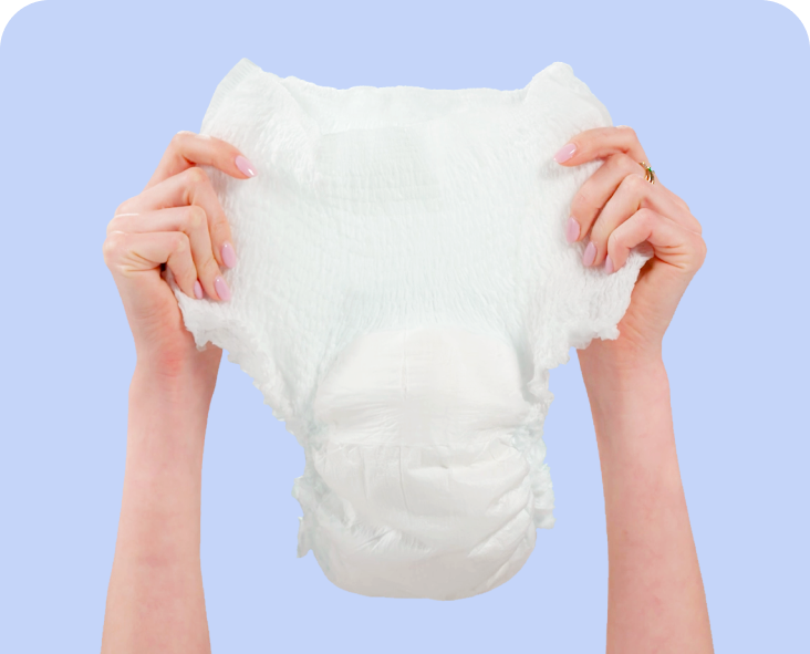 Image of two hands holding up an adult diaper.