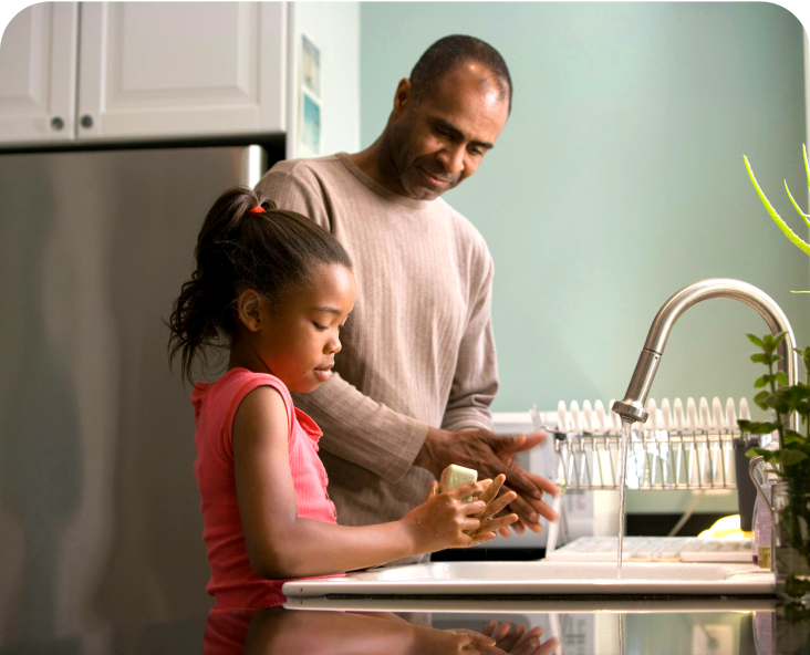 Father and child washing dishes