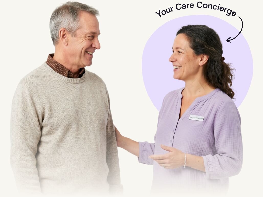 Friendly, professional woman speaking with a relaxed senior man. Above the woman it says "Your Care Concierge" with an arrow pointing to her.