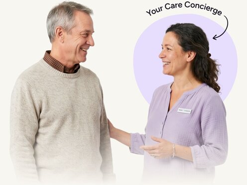 Friendly, professional woman speaking with a relaxed senior man. Above the woman it says "Your Care Concierge" with an arrow pointing to her.