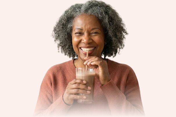 Happy senior woman drinking a nutrition shake