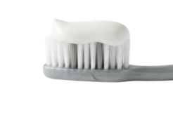 Grey toothbrush with white toothpaste